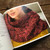 Malabrigo pattern book #17 Ponchos & Familia, vibrant red and yellow knitted scarf on a woman, showcasing colorful chunky knitwear design.