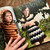 Malabrigo Pattern Book #9, kids' sweaters and vest, featuring Niños designs, showcasing a child in a striped orange sweater and another in a navy and white dress.