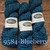 Studio Donegal Soft Marls marled merino wool yarn in blueberry, showcasing skeins of blue, white-marled yarn with Studio Donegal branding and wooden background detail. Studio Donegal Soft Marls marled merino wool yarn in blueberry, showcasing skeins of blue, white-marled yarn with Studio Donegal branding and wooden background detail.