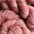 Hand Dyed Superwash Merino Wool Yarn in Mauve Pink, soft pink yarn skeins twisted together, showcasing delicate color and texture.