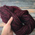 Handmade Merino Wool Yarn, Black Cherry Artisan Luxury by Forever Winding Wool brand, features rich burgundy and subtle pink tones, perfect for knitting and crochet projects, a luxury yarn skein in merino wool.