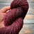 Handmade Merino Wool Yarn by Brand Forever Winding Wool, Black Cherry Artisan Luxury Yarn, maroon and black variegated Merino wool yarn for knitting and crochet projects.