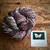 Luxury Handmade Merino Wool Yarn - Midnight Bloom by Forever Winding Wool, a brand of high-quality yarn featuring multicolored speckled design in pink, blue, and white tones.