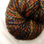 Multicolored handspun merino wool yarn skein, Forever Winding Wool brand, featuring shades of orange, blue, yellow, and brown in a DK weight yarn.