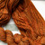 Forever Winding Wool Luxury Handmade Merino Wool Yarn in Orange Spice, a Light Worsted Weight DK yarn with warm orange hues and soft texture on a white background.