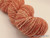 Luxury Handspun Merino yarn, Peach Rose Elegance, 2-ply Sport/DK wool skein in a soft peach and rose color, artisan crafted.
