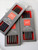 Lantern Moon Ebony DPNs, handcrafted luxury double pointed knitting needles, ebony, grey packaging, red accents, high-quality knitting tools.