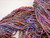 Forever Winding Wool Moody Blue Handmade Merino Wool Bulky Yarn by Forever Winding Wool, a multicolored handspun yarn featuring Merino wool, blue, pink, purple, and orange hues.