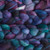 Malabrigo 100% Merino Wool Roving, Whales Road, 4oz, 3-color blend of purple, blue, teal, suitable for spinning and felting fiber crafts with soft, colorful texture.
