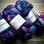 Malabrigo Nube Whales Road 100% Merino Wool Roving, 4oz fiber suitable for spinning and felting, featuring a vibrant blue, purple, and pink color combination.