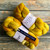 Malabrigo Merino Wool Roving "Malabrigo Nube Frank Ochre" 4oz blend of warm yellow and orange hues, ideal for spinning and felting with soft, braided texture.