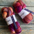 Malabrigo Nube Wool Roving in Archangel, 4oz hand-dyed 100% Merino fiber combed top in vibrant purple, pink, and orange hues.