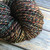 Bulky Artisan Merino Yarn by Forever Winding Wool in Kimball Coal Dust, featuring a multicolored skein with brown, green, and orange shades, 100% wool yarn. Bulky Artisan Merino Yarn by Forever Winding Wool in Kimball Coal Dust, featuring a multicolored skein with brown, green, and orange shades, 100% wool yarn.