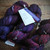 Malabrigo Rios Yarn in Syrah Grapes, a deep wine purple hand-dyed worsted merino yarn, in a skein form, showcasing its rich color tones.