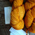 Malabrigo Worsted Sunset yarn skeins, warm orange hand-dyed merino wool, two bundles on wooden surface with brand tags visible, vibrant orange color.