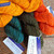 Malabrigo Worsted yarn skeins in Warm Orange, teal, and dark brown, hand-dyed merino wool in Sunset, Forest, and another orange hue.