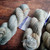 Malabrigo Rios Magnolia 263, Neutral Worsted Merino Yarn skeins on a wooden surface, showcasing soft gray and beige hues with subtle texture.