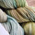 Malabrigo Rios Gardenia Superwash Merino Worsted Yarn skeins in soft pastel hues, showcasing gentle color transitions and soft texture.