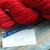 Malabrigo Rios yarn in Ravelry Red, a vibrant classic red superwash merino yarn, skein with label displaying product name and color code, showcasing the yarn's texture and brand details. Malabrigo Rios yarn in Ravelry Red, a vibrant classic red superwash merino yarn, skein with label displaying product name and color code, showcasing the yarn's texture and brand details.