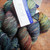 Malabrigo Rios Pocion yarn, Jewel-Tone Worsted Merino, colorful skeins in blues, greens, yellows, and reds, neatly arranged.