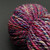 Single skein of Fiesta Bulky Handspun Merino Yarn featuring vibrant, multi-colored jewel tones in a 2-ply artisan twist.
