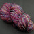 Forever Winding Wool Fiesta Luxury Handspun Yarn, bulky 2-ply fine Merino, multicolored skein with pink, blue, purple, and green hues.