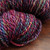 Multicolored Fiesta Luxury Handspun Yarn by Forever Winding Wool, featuring a mix of pink, purple, blue, and yellow hues in a bulky 2-ply fine Merino skein.
