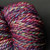 Multicolored Fiesta Luxury Handspun Yarn by Forever Winding Wool, featuring pink, purple, blue, and yellow hues in a bulky 2-ply fine Merino skein.