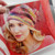 Malabrigo Pattern Book 11: Anniversario, colorful multicolored knit beanie on a smiling blonde woman, showcasing vibrant pink, yellow, blue, and red hues.