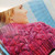Malabrigo Pattern Book 7: Rasta In Brooklyn, showcasing vibrant pink knitted fabric, with a woman wearing a chunky knit sweater, highlighting color and texture.