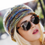 Malabrigo Pattern Book 7: Rasta In Brooklyn, featuring a multicolored knitted beanie, close-up of stylish woman wearing sunglasses and chunky yarn hat.