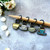 Detailed view of vintage-style teacup stitch marker charms in blue and cream.