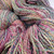 Multicolored handspun sport/DK merino wool yarn, The Rogue Dye Lot Studio Variant HS-866B, Forever Winding Wool, pastel pink, blue, green, and yellow hues.