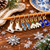 Set of 8 Winter Stitch Markers on wooden needle, featuring enamel knitting notions in festive shapes and colors, including ice skate and mitten designs.