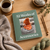 Laine Publishing's 52 Weeks of Accessories book with green cover and orange knitted hat on woman, surrounded by yarn and knitting needles.
