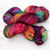 Malabrigo Vientos Yarn in Variegated Rainbow colors, skein of multicolored yarn with pink, blue, green, yellow, and purple hues.