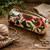 Bruno Visconti Canvas Knitting Notions Pouch with floral design, gold zipper, and knitting supplies on a wooden table, showcasing colorful yarn and tools.