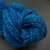 Handspun Bulky Merino Yarn in Freedom Tonal Blue, a vibrant blue yarn with subtle tonal variations, neatly coiled and displayed.