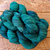 Full view of a Malabrigo Rios Pines 213 worsted yarn hank, showing deep forest-green tonal variations.