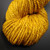 Twisted hank of Happiness golden yellow bulky handspun merino wool yarn showing its rich color and handmade texture.