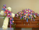 Casket spray and cross arrangement on a standing easel