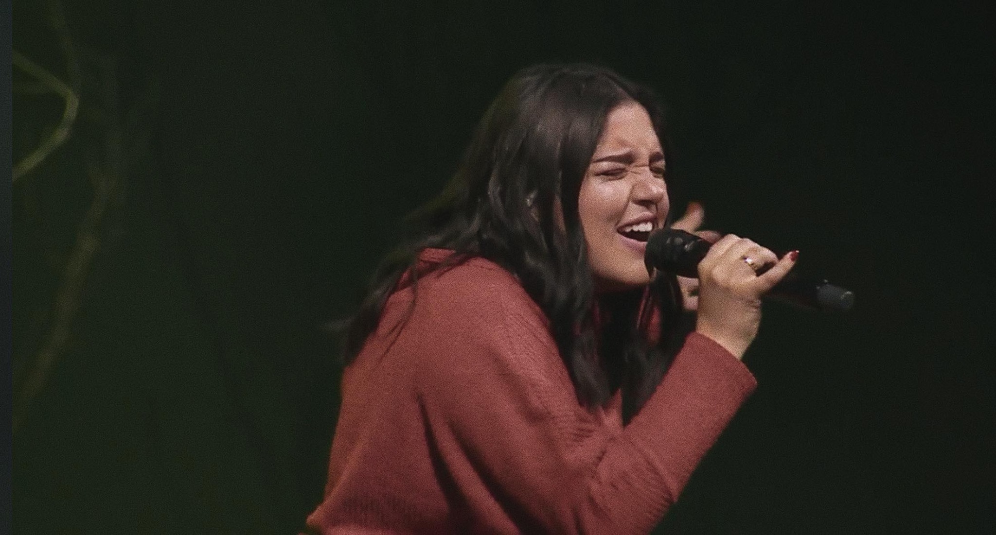 a person singing into a microphone