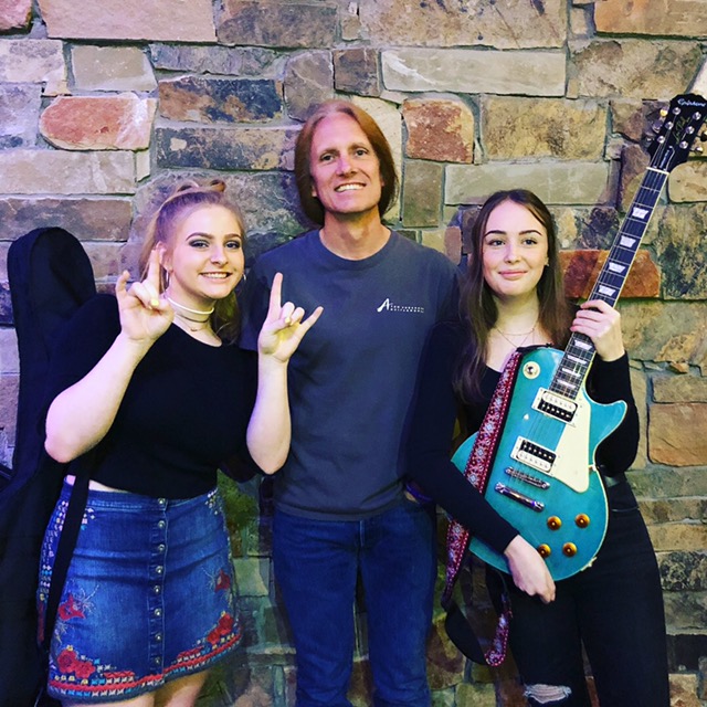 a group of people holding guitars