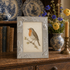 4.	Polished silver plated Sixtrees photo frame with raised nature design and velour strut back