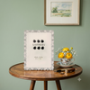 Antonia cast metal 5 x 7 inch photo frame featuring floral detailing, sparkling crystal-style accents and soft pearl-effect teardrop embellishments.