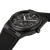 Angled view highlighting the unique black-and-grey marbled pattern of the 40.5 mm forged-carbon case.