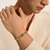 White male model wearing John Hardy Spear flex cuff in 14k yellow gold