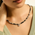 Model wearing JH Lovestruck Heishi pendant necklace in sterling silver with black onyx beads and 1.25 TCW diamond