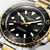 Longines HydroConquest L3.769.3.56.7 Swiss Made 42mm quartz dive watch with black sandblasted dial, black unidirectional rotating bezel, and stainless steel with yellow PVD-coated bracelet.