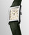 Longines DolceVita L5.512.4.08.2 Swiss Made quartz watch with an ivory gilt flinqué dial, applied Roman numerals, gilt hands, rectangular stainless steel case, and olive green alligator leather strap.